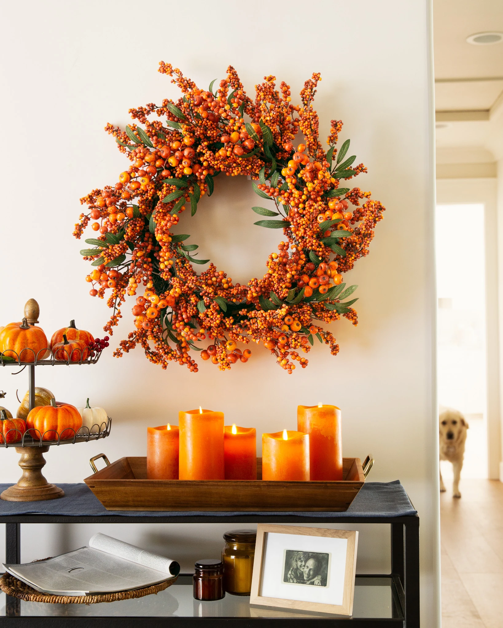 Fall fireplace mantel décor with fall wreath, pumpkins, and LED candles on sidetable